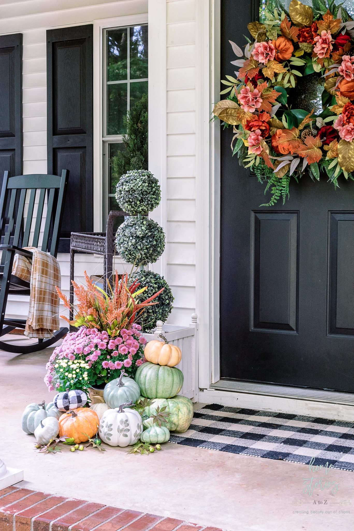 colorful fall porch with piles of styled pumpkins